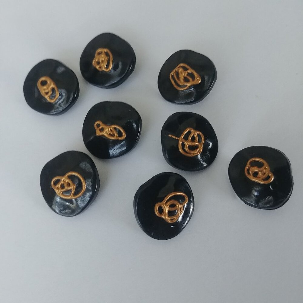 4/$20 Set of 8 eight glossy black plastic buttons with gold drizzle detail